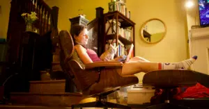 A woman reading the book in compression socks