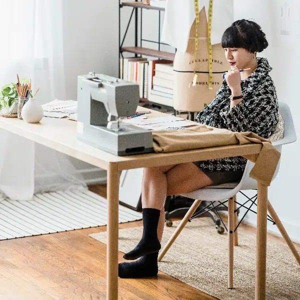 A woman sitting at desk with compression socks
