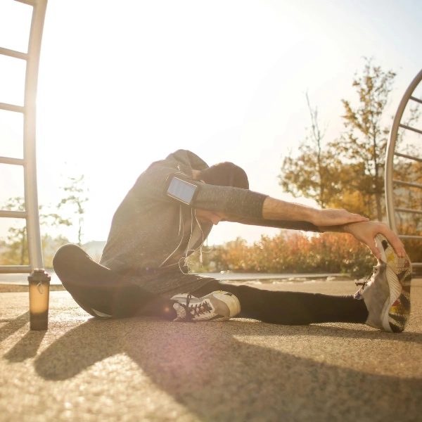 sportsman stretching on sports ground in