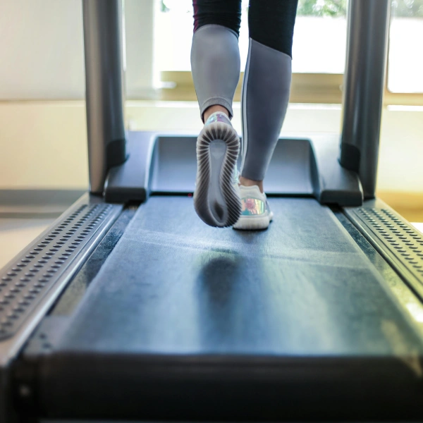 Person using treadmill in compression wear
