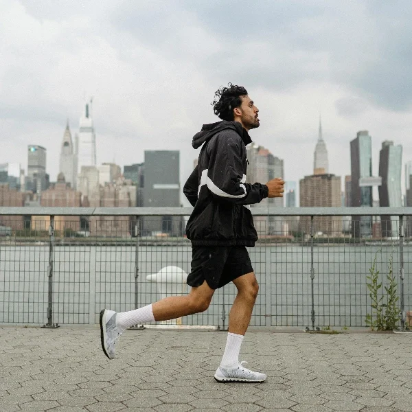 A man is running in compression socks.