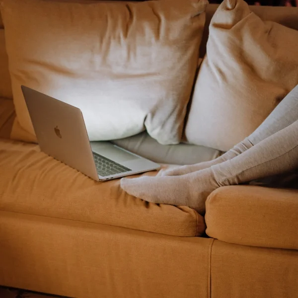 person in compression socks lying on sofa