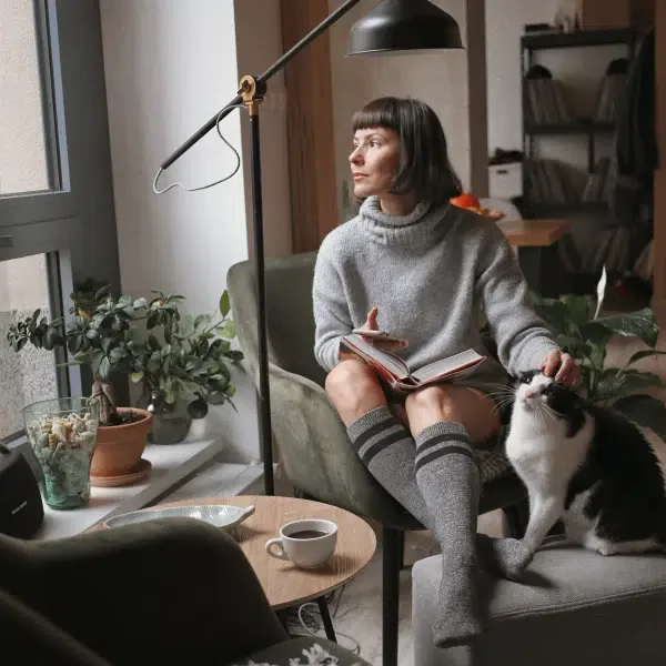 A woman sitting in the sofa in compression socks