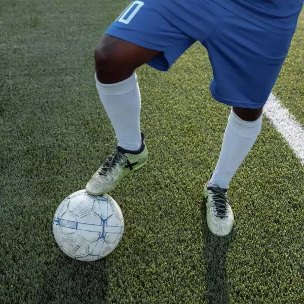 A soccer player wears compression socks for exercise