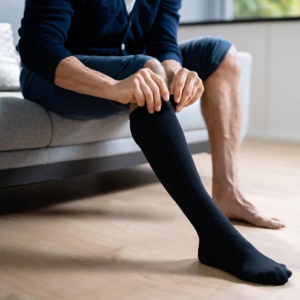 A person is wearing compression socks.