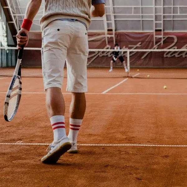 Persons playing tennis in compression socks